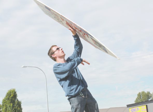 Christian Korsgren, 20, spins a sign for Mattress Depot USA.