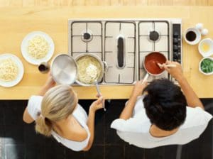 high angle view of a young couple cooking food in the kitchen
